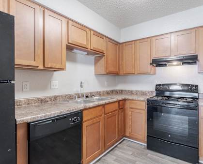 Pet-Friendly Apartments in Antioch, TN– Hickory Lake – A kitchen with black appliances and wooden cabinets.