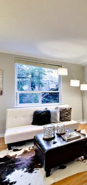 a living room with a couch and a large window