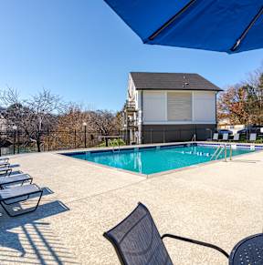 Pet-Friendly Apartments in Antioch, TN– Hickory Lake – A pool area with sun loungers and a building in the background.