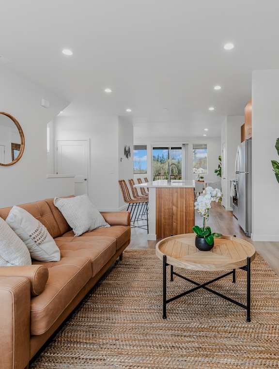 Thrive at Green Mountain Townhomes in Camas, WA Model Living Room with Fireplace and Kitchen