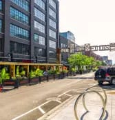 a city street with a car driving down it
