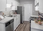 Thumbnail 10 of 33 - Kitchen with stainless appliances at Canyon Park, Beaverton, OR
