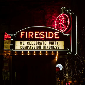 Neon Sign Reading Fireside Outside of Building