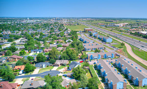 an aerial view of a suburb of a city with highways and houses