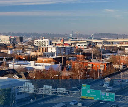 A cityscape with buildings and a highway.