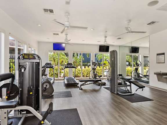 A spacious home gym with a variety of exercise equipment.
