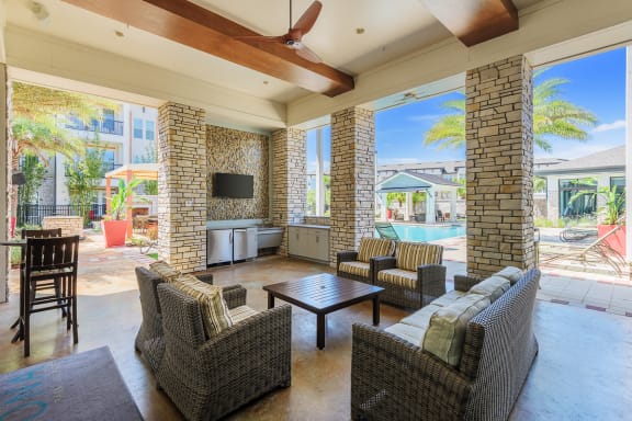 Nona Park Village Apartments pool area outdoor kitchen with grilling stations