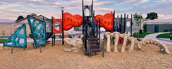 a playground with a slide and other playground equipment