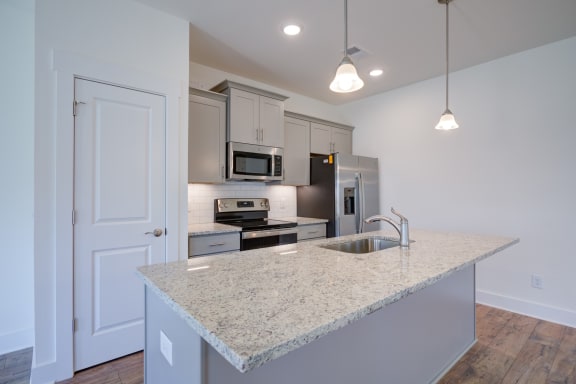 a kitchen with an island and stainless steel appliances