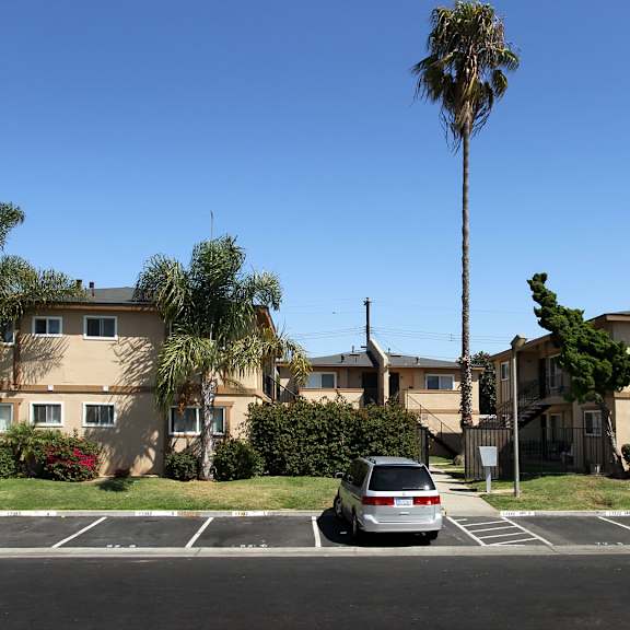 The front of the Mesa Vista Apartments building with a flag flying in the background.