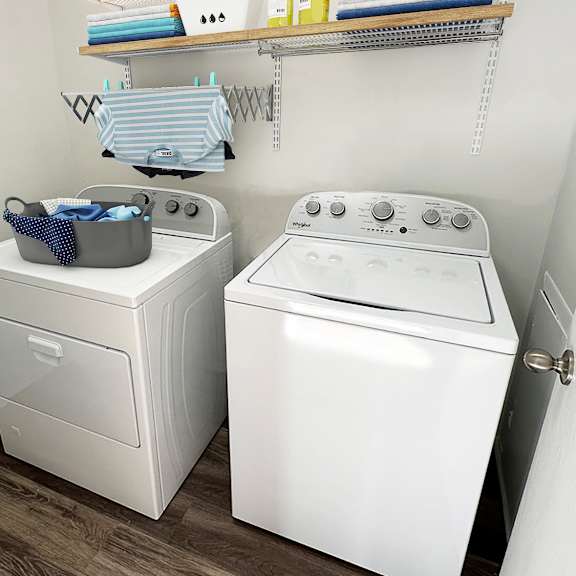 A white washing machine and dryer in a small laundry room.