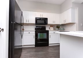 Modern kitchen with black appliances | Emblem Alpharetta
