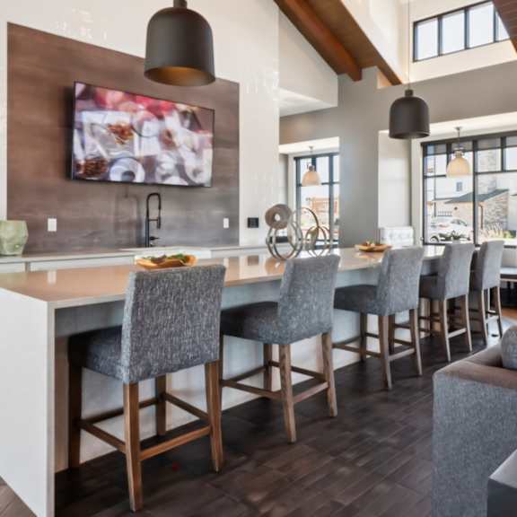 A patio with a table and chairs and a television.