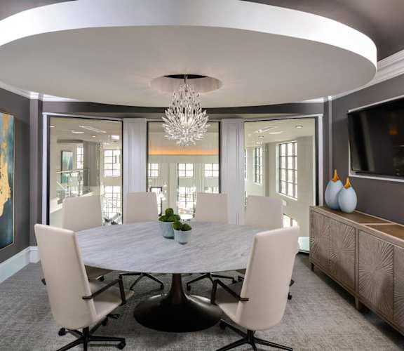 a dining room with a table and chairs and a chandelier