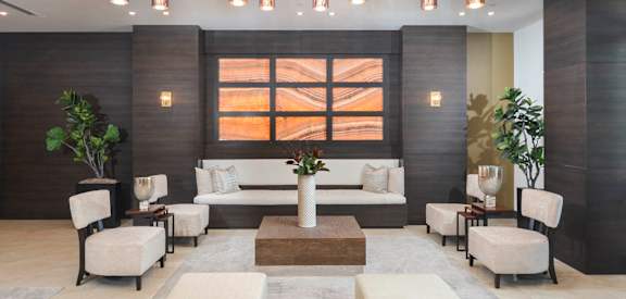 Lounge with a large chandelier hanging from the ceiling District West Gables West Miami, FL