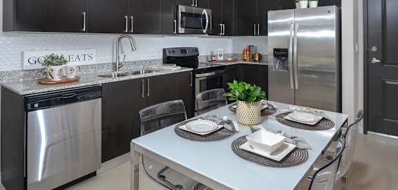 gourmet kitchen with granite countertops District West Gables West Miami, FL