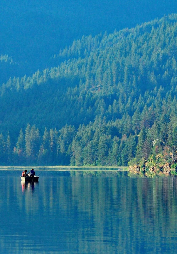 a group of people in a boat on a lake