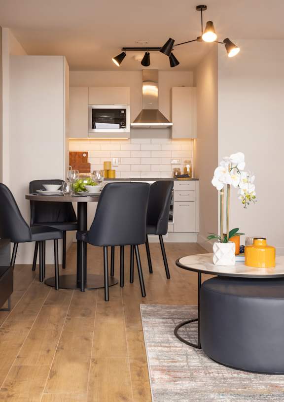 a kitchen and dining area with a table and chairs