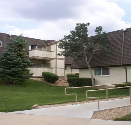 an apartment complex with a grassy area and trees  at Mountain Terrace, Colorado, 80031