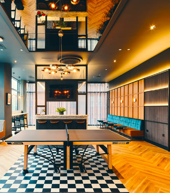 a dining room with a ping pong table and a large window at The Rail, St. Louis, 63110