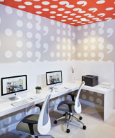 a white office with two computer monitors and two chairs