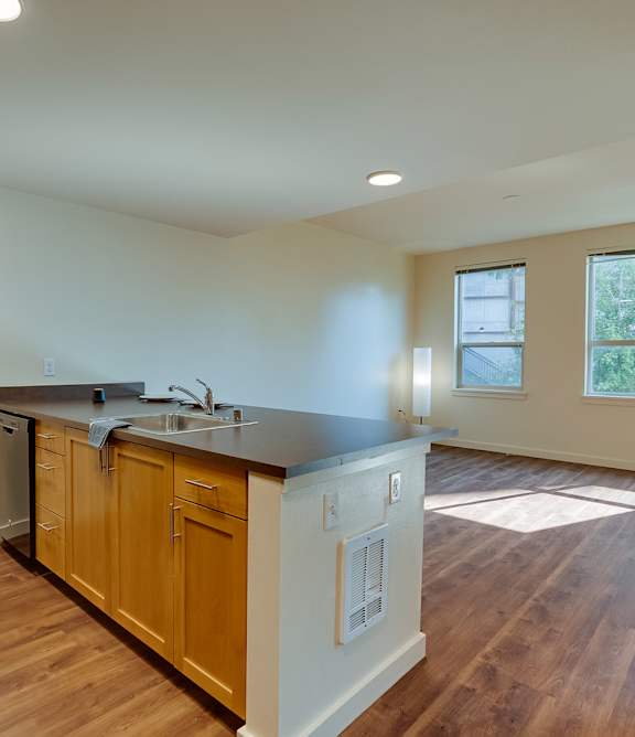 A kitchen with wooden cabinets and a black countertop.