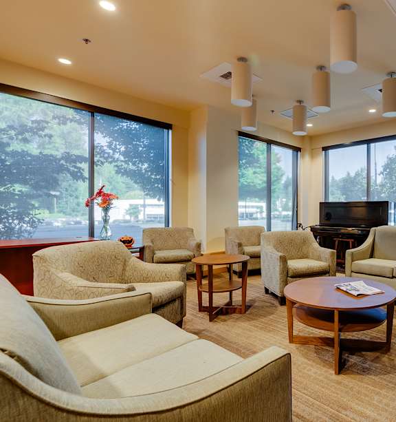 A living room with a fireplace and a flat screen TV.