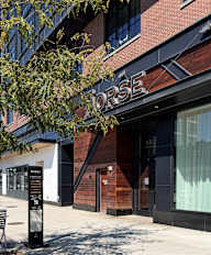 A building with a sign that says "Rose" on it.