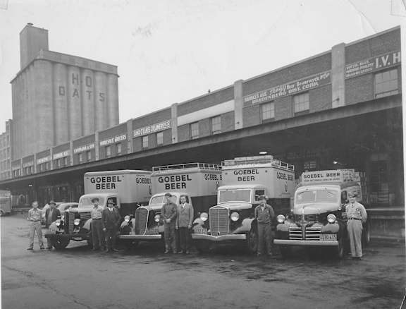 a group of people standing in front of a line of food trucks at The Lofts at Elk Terminal Apartments , Buffalo, New York