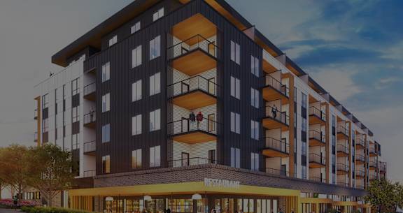 A modern apartment building with a restaurant on the ground floor.