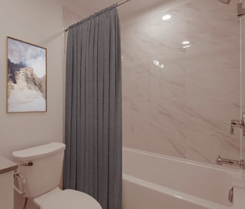 A bathroom with a toilet, a sink, a bathtub and a shower curtain.
