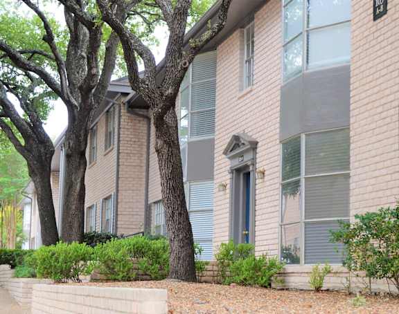 a view of the outside of a building with trees