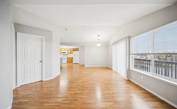 a bedroom with a sliding glass door and hardwood floors  at ReNew Bayshore Townhomes, Alaska