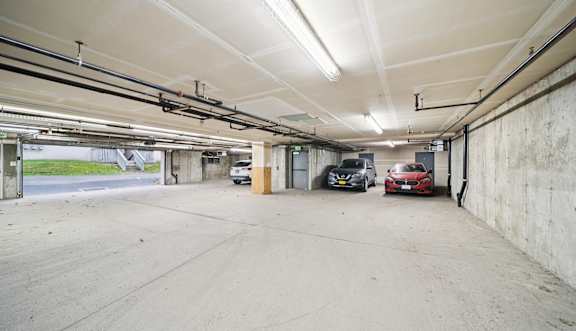 an empty parking garage with a white garage door  at ReNew Bayshore Townhomes, Anchorage