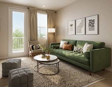 A living room with a green couch, a coffee table, and a rug.