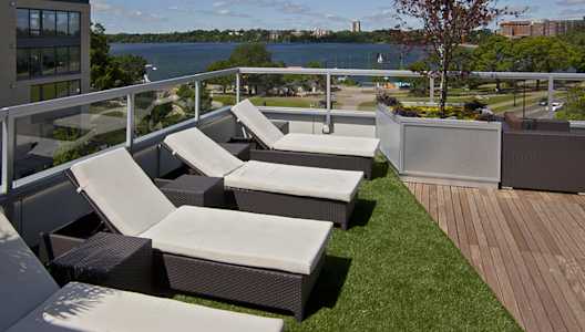 A patio with a view of the water and buildings.