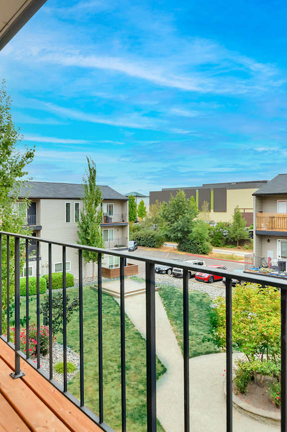 A small pool in a backyard with a house in the background.