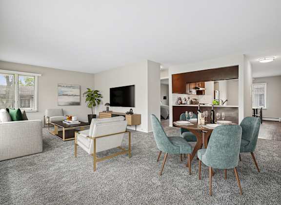 A living room with a grey carpet and furniture.