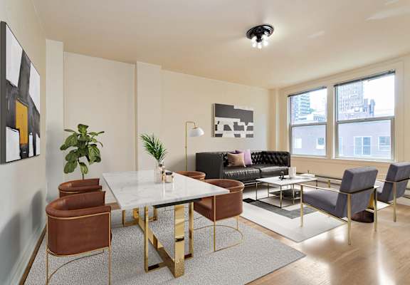 A modern living room with a white table and brown chairs.