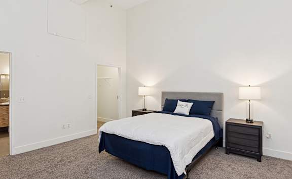 an empty living room with wood floors and windows at Residences at South High, Pittsburgh
