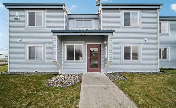 Father playing with kids in apartment at Woodridge Apartments, Kenai, AK
