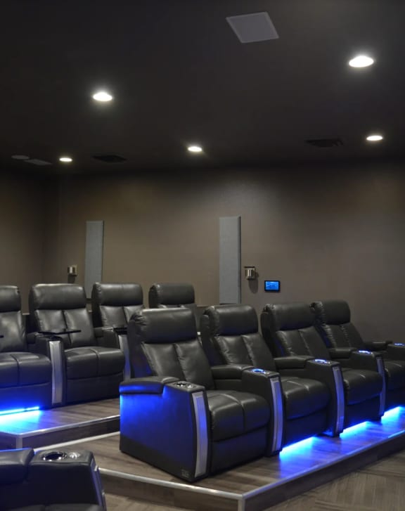 a large auditorium with rows of chairs and blue lights