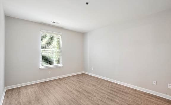 a bedroom with a large window and a carpeted floor at Woodgate, Charlottesville, Virginia