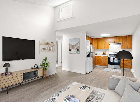 A living room with a television, a couch, and a coffee table.