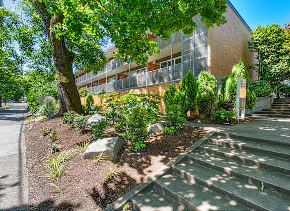 A building with a green lawn in front of it.