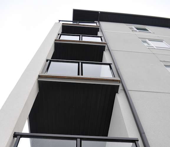 A building with a balcony and a glass railing at The Laurent at Laurel Apartments, Edmonton, AB, T6T 2T5