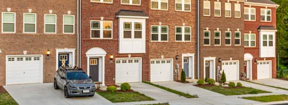 a row of townhomes with a blue sky in the background
