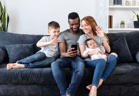 Family on the couch with phone