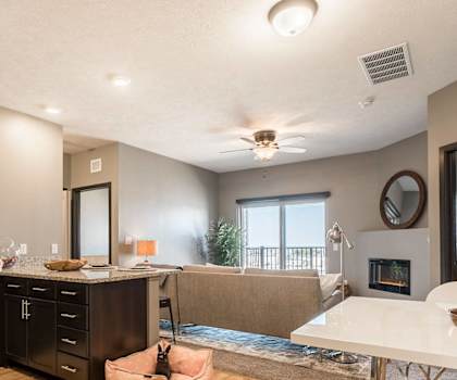 an open kitchen and living room with a fireplace and a table