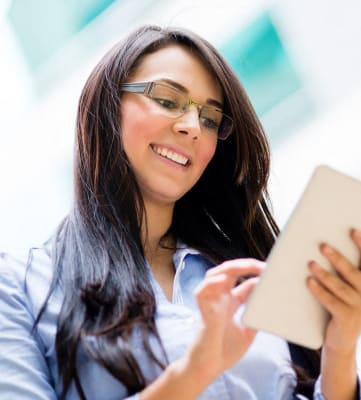Woman on tablet  l Alderwood Park  | Apartments in Newark, CA Near San Francisco
